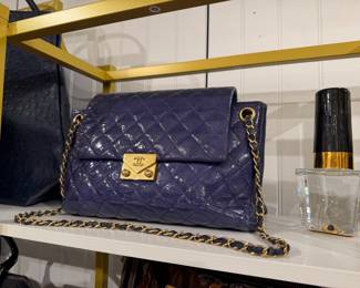 Chanel blue quilted leather flap shoulder bag with gold chain strap and CC turn-lock closure.