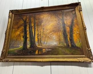 A framed landscape oil painting of an autumn forest path, likely European school decorative landscape, circa early–mid 20th century (1920s–1950s).