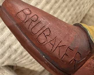 A whimsical hand-painted sculpture of an anthropomorphic dog dressed as a cavalry soldier, signed Brubaker, likely contemporary American folk art, circa 1990s–2000s.