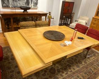 Expandable Mid-Century Oak Dining Table with Pull-Out Leaves and Pedestal Base.