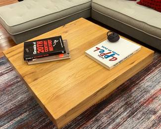 Modern live edge style wood coffee table with sculptural fluted pedestal base.