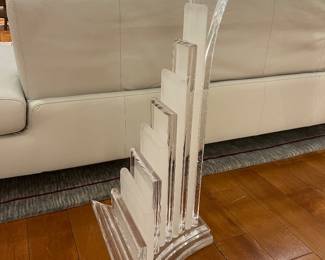 Modern glass console table with sculptural clear acrylic base in Art Deco style.