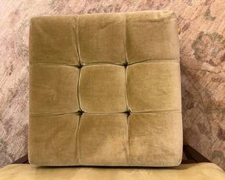 Vintage tufted upholstered ottoman bench with wood frame and brass casters.