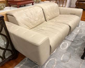 Contemporary Tufted Cream Leather Sofa with Adjustable Headrests and Chrome Legs.