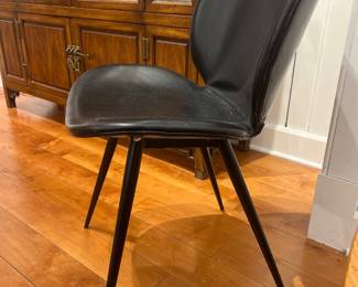 Modern black upholstered dining chair with metal legs by Roche Bobois – sleek contemporary design.