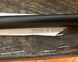 Rolling Armchair – Contemporary black armchair with cushioned seat, curved backrest, and rolling casters for easy mobility.