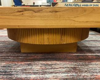 Modern live edge style wood coffee table with sculptural fluted pedestal base.