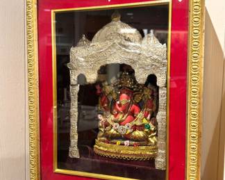 A framed Hindu devotional shadowbox featuring the deity Ganesha beneath an ornate temple arch, Indian religious shrine art, circa 1970s–1990s.