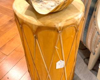 A large traditional hand drum with a wooden shell and laced hide drumhead, likely a West African djembe-style drum, circa mid–late 20th century.