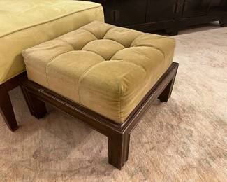 Vintage tufted upholstered ottoman bench with wood frame and brass casters.
