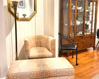 A modern upholstered lounge chair with matching ottoman in a spotted deer-inspired fabric, likely contemporary designer furniture circa 2000s–2010s, in a style similar to pieces by Kelly Wearstler.