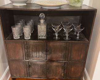 Asian style dark wood cabinet with paneled doors and decorative iron hardware.