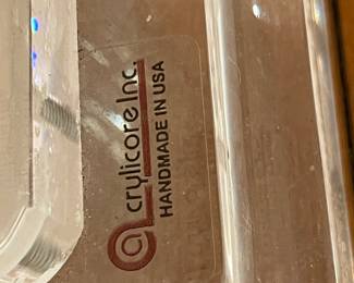 Modern glass console table with sculptural clear acrylic base in Art Deco style.