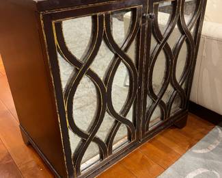 Modern Mirrored Accent Cabinet with Distressed Gold Trim and Glass Panel Doors.