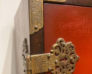 Antique Asian Red Lacquer Cabinet with Ornate Brass Hinges and Decorative Hardware.