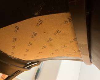 Black Leather Chaise Lounge – Modern black leather reclining chaise lounge chair with curved metal frame and head cushion, minimalist contemporary design.