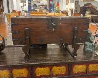 Antique wooden tabletop book press with iron hardware and trestle base.
