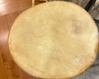 Hand-carved rope-tension African style drum with natural hide head and wood body.