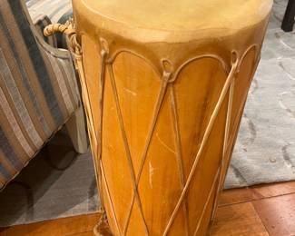 Hand-carved rope-tension African style drum with natural hide head and wood body.