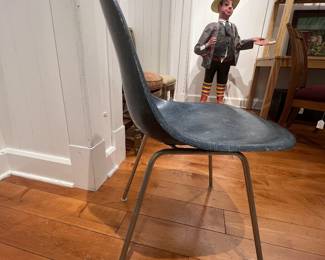 Mid-century molded fiberglass shell chair with metal legs in blue/gray finish.