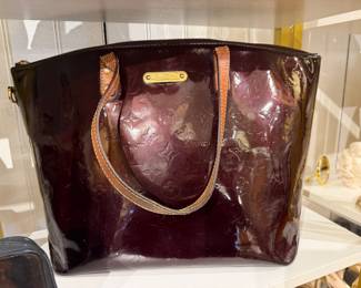 Burgundy patent leather monogram tote bag with shoulder straps.