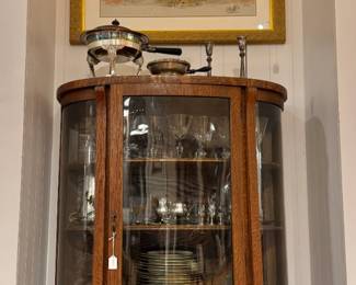 American Oak Curved-Glass Curio - turn-of-the-century (c. 1900) Golden Oak display cabinet. Above it is a Mother & Children Portrait