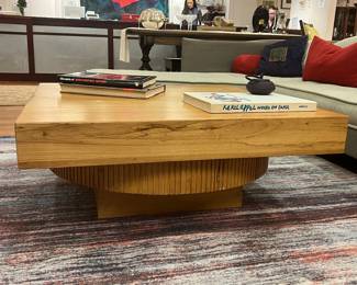 Modern live edge style wood coffee table with sculptural fluted pedestal base.