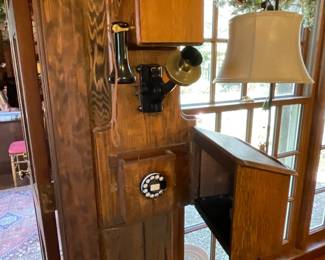 Vintage wall-mounted wooden magneto telephone from the early 20th century