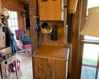 Vintage wall-mounted wooden magneto telephone from the early 20th century