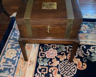 Vintage box on stand with brass binding and lock