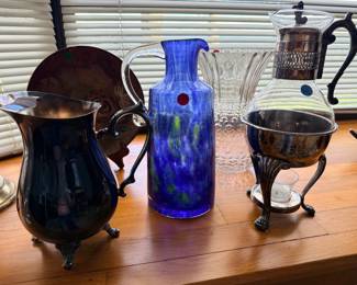 Silver and art glass pitchers and silver coffee urn and stand
