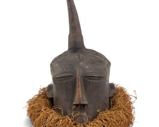 430 An African Songye/Luba carved wood mask 20th century; Republic of the Congo Possibly Bwadi bwa Kifwebe, with fibrous neck adornment Overall: 19.5" H x 15" W x 17" D Estimate: $300 - $500