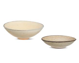 270 Harrison McIntosh (1914-2016) Two glazed stoneware low bowls, mid-20th century Smaller impressed with potter's chop mark: HM; applied paper label to the underside: Handthrown Stoneware / Harrison McIntosh / Claremont / California; larger incised: McIntosh [script] Each with ivory glaze, one with sgraffito lines to well interior 2 pieces Larger: 2" H x 6" Dia.; Smaller: 1.375" H x 5.125" Dia. Estimate: $500 - $700