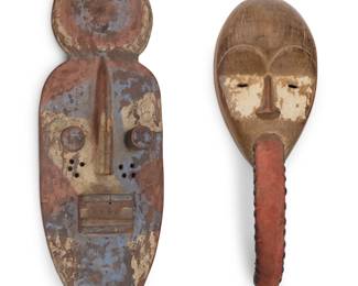 431 Two West African polychrome carved wood masks 20th century Comprising one Grebo mask and one possibly Guro mask 2 pieces Larger: 20.5" H x 7.25" W x 4" D; Smaller: 15.5" H x 5.625" W x 5.75" D Estimate: $200 - $300