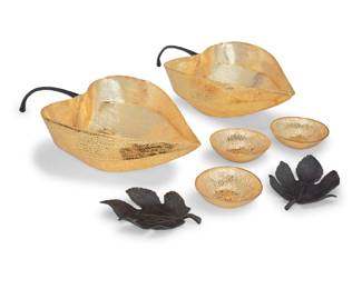 58 A group of seven Michael Aram table items Late 20th/early 21st century Each impressed or marked in relief: Aram Comprising a pair of 'Gooseberry' pierced gilt-metal bowls (4.125" H x 18.625" W x 9.125" D), three 'Lemonwood' gold-toned metal bowls (1.25" H x 4.375" Dia.), and a pair of 'Winter Leaves' patinated metal dishes (6.125" W x 4.625" D) 7 pieces Estimate: $200 - $300