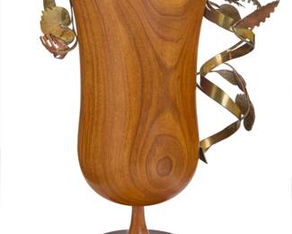 60 Karl Hagenauer (1898-1956) A turned wood and mixed metal cup, mid-20th century Impressed in the brass ribbon: [artist's cipher] / Made in Austria With applied hand-wrought brass and copper foliate elements 14.25" H x 11" W x 6" D Estimate: $1,000 - $2,000