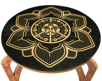 341 Shepard Fairey (b. 1970) Mandala wood table, 2009 Mixed media, wood, and glass Signed and dated: Shepard Fairey 09; fabricated and further signed by Chris Aultman and Derric Swinfard 23.625" H x 44.75" Dia. Estimate: $4,000 - $6,000