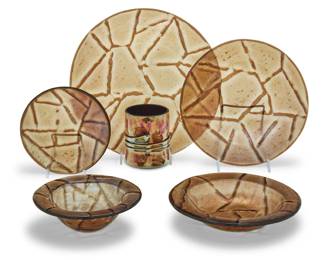 309 A Paul Hathcoat iridescent glass partial dining service Late 20th century Plates and bowls with etched initials and date to underside: PH 94; cups with etched signature and date: Esteban Prieto / 1985 Comprising: 11 dinner plates (11.625") 11 salad plates (9.5") 12 bread & butter plates (6.5") 12 soup bowls (8.375") 12 fruit/dessert bowls (6.75") together with 6 Esteban Prieto cups (3.75" H) 64 pieces Estimate: $300 - $500