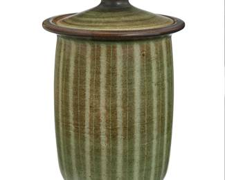 245 Harrison McIntosh (1914-2016) A glazed stoneware lidded jar, mid-20th century Impressed with potter's chop mark: HM; applied paper label to the underside: Handthrown Stoneware / Harrison McIntosh / Claremont / California With pale green glaze and sgraffito lines 9" H x 5.5" Dia. Estimate: $2,500 - $3,500