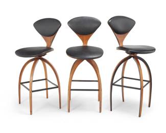 30 Norman Cherner (1920-1987) A set of three 'Swivel Cherner' stools for Plycraft Inc., mid-20th century One with Plycraft Inc. fabric tag applied to underside The chairs with molded plywood and original vinyl seats raised on molded plywood curved legs joined by an enameled steel box stretcher 3 pieces Each: 42" H x 17.5" W x 21" D Estimate: $700 - $900