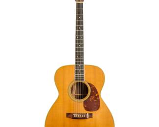 371 A Martin M-36 acoustic guitar Circa 1979 Impressed to interior: M-36 / 414240; headstock marked: Martin & Co. / EST. 1833 With Indian rosewood back and sides, housed in a hardcase Guitar: 41.25" H x 16.25" W x 5.5" D; Hardcase: 46 H x 18.25" W x 7.25" D Estimate: $1,000 - $2,000