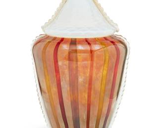 141 A large Cenedese Murano art glass lidded vase Mid/late 20th century Etched to underside: Cenedese With vertical stripes, the lid with gilt-embedded accents Overall: 24.5" H x 13.375" W x 12.75" D Estimate: $400 - $600