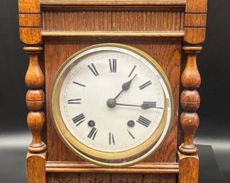Antique French Arts  Crafts wooden mantel clock featuring intricate carvings and Roman numeral hour