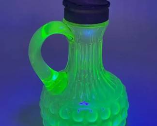 This is a Vaseline glass hobnail cruet with a handle and spout