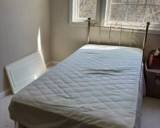 Twin bed with brass headboard