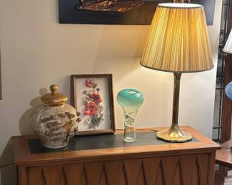Heritage MCM cabinet with black top, art glass vase, brass lily pad base lamp 