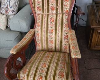 Carved, upholstered rocking chair