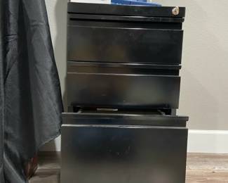 Rolling Metal Filing Cabinet Full Of A Variety Of Office Supplies