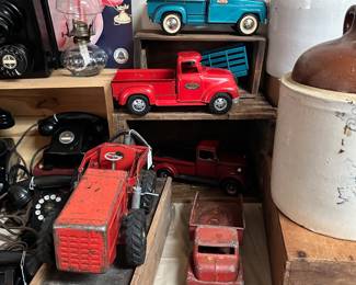 Vintage toy trucks and jugs