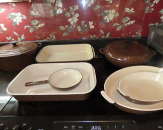 Brown Le Crueset casseroles and dishes.